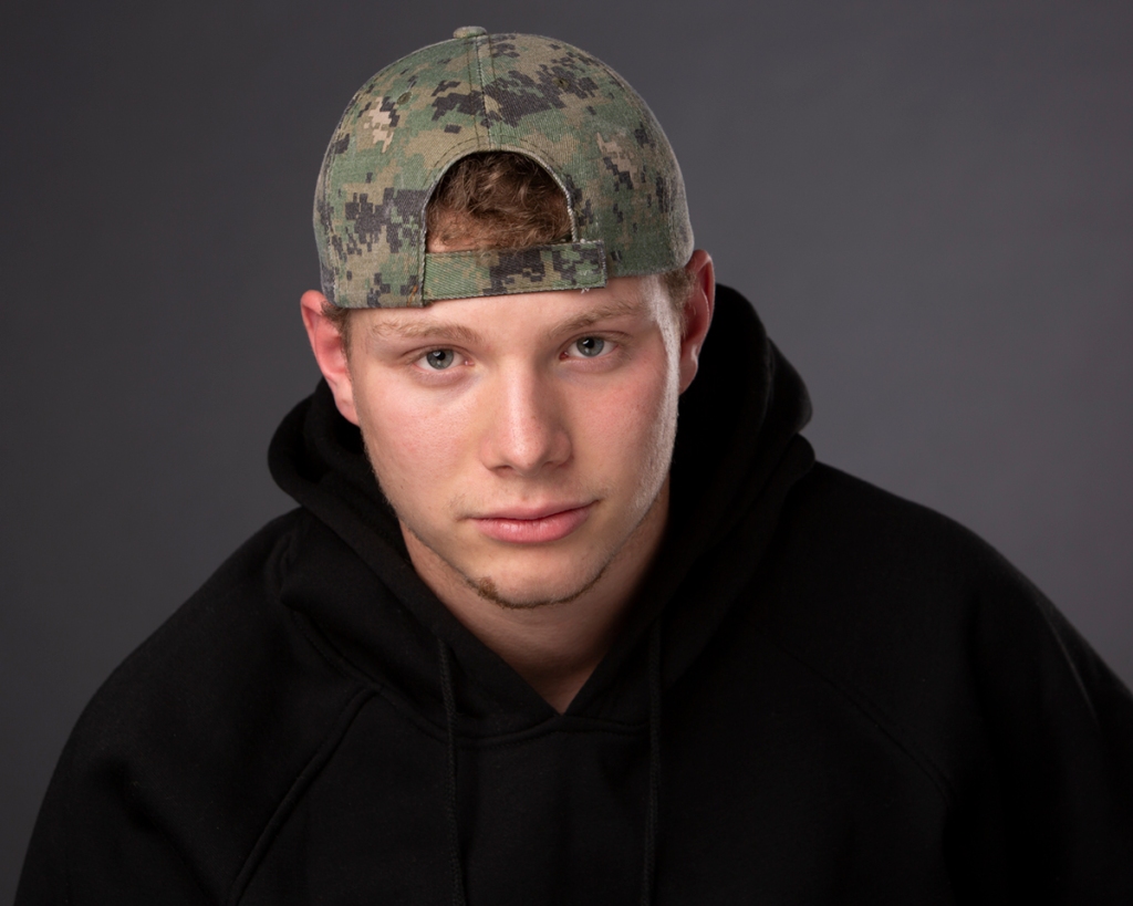 Teenager with baseball cap headshot