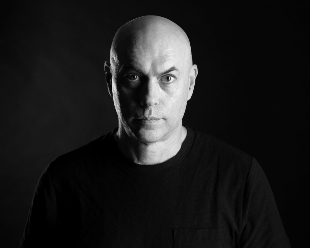 Headshot of musician, Jeffrey M. at studio in black and white